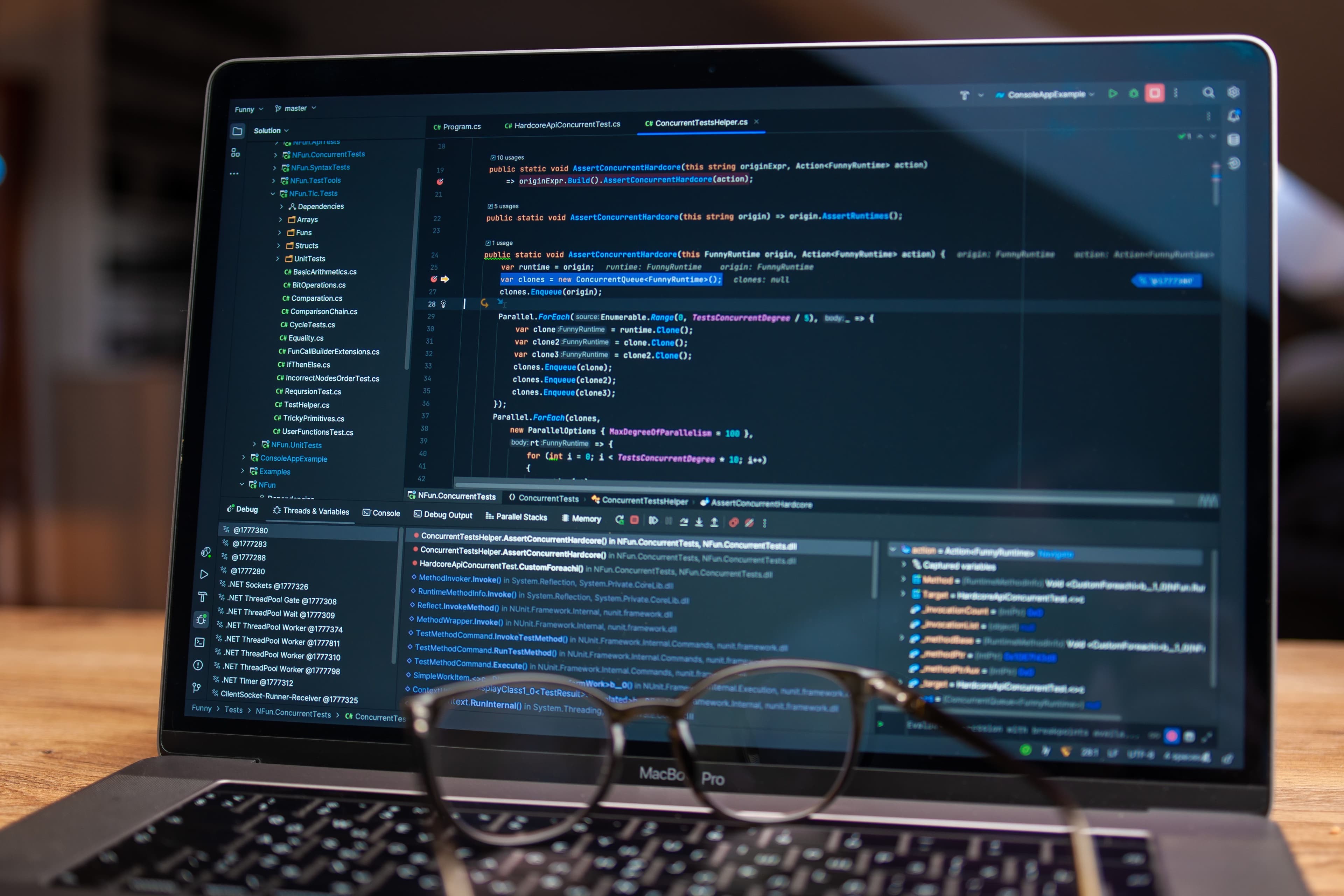 Laptop screen showing debugging software with code, perfect for tech and software development.